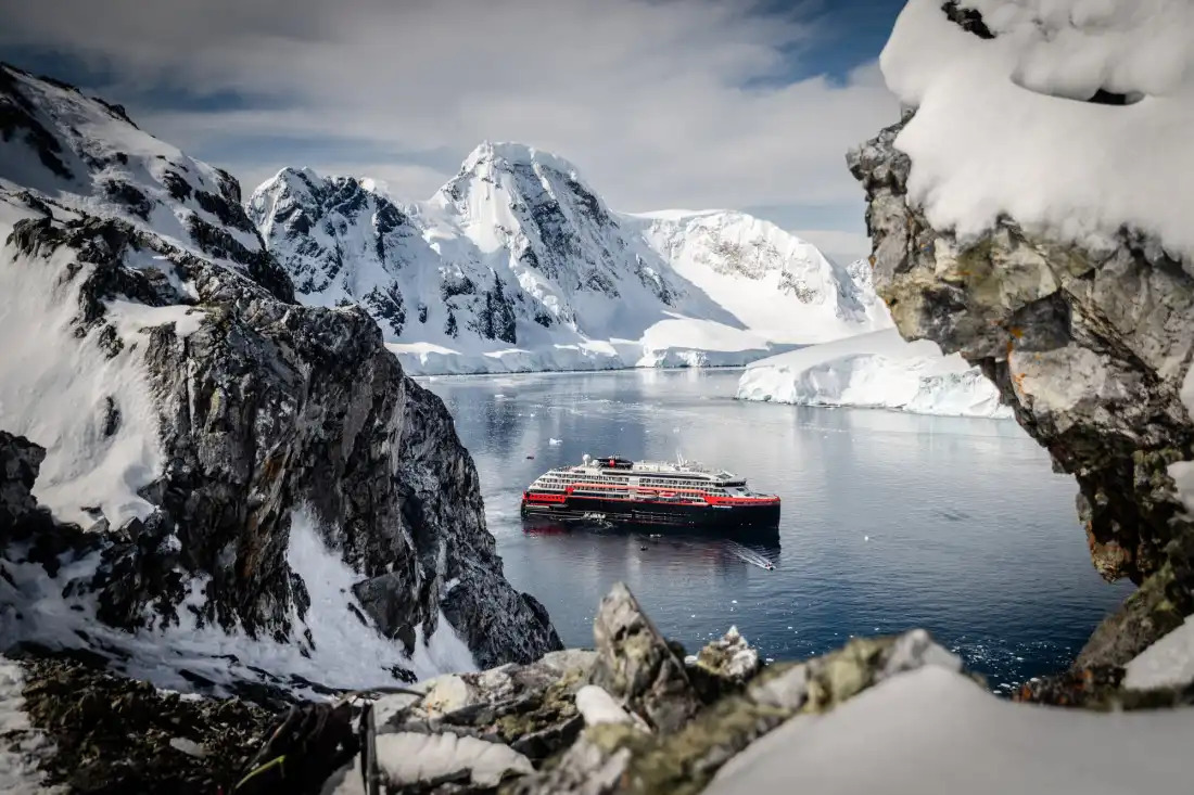 Red-and-black cruise ship in icy waters